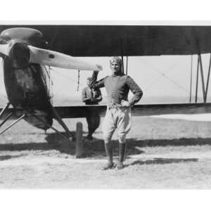   General Mitchell standing beside a pursuit plane graphic. Mitchell
