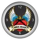 Carsons Collectibles Silver Wall Clock of Flaming Winged Heart says 